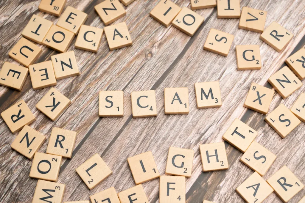 SiteGuard WAF flaw actively exploited for root-level OS command injection Scrabble tiles on a wooden background spell out the word 'scam', concept for deception and trickery