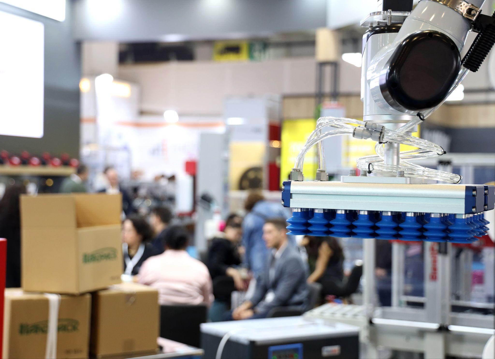 Exhibitors and hosted buyers to meet at Istanbul's Eurasia Packaging 2026: a robotic vacuum gripper lifting cartons on an exhibitor stand at Eurasia Packaging Istanbul